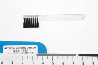 Plastic brush prop used by Lois Carrington