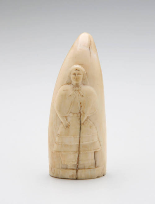 Scrimshaw tooth with relief carving of child