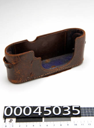 Bottom half of a broken brown leather camera case (the top half is 00045034) for Leica camera (00045033)