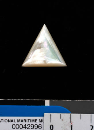 Triangular shaped piece of gold-lip oyster shell