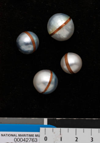 Cultured half-pearls joined with copper bands