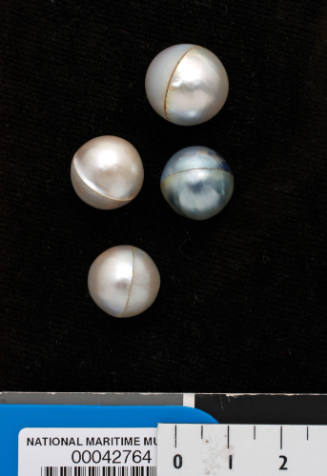 Four round cultured pearls, consisting of two half pearls (or mabe pearls) joined