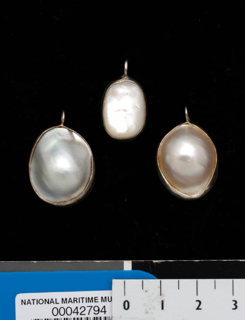 Three cultured blister pearl and electroplated silver pendants