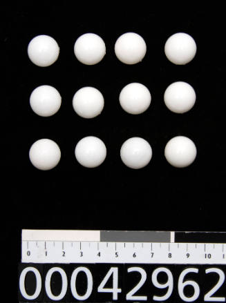 Twelve white plastic, semicircle shaped nuclei