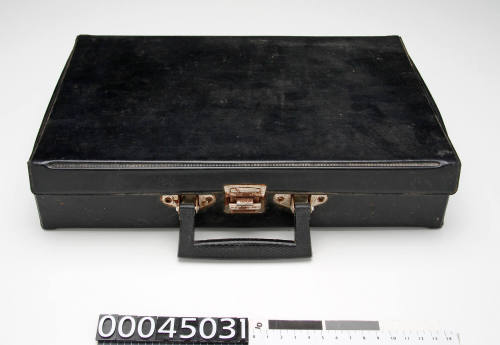 Black plastic briefcase with black plastic handle and metal clip, used to store cassette and recording tapes ANMS1281[019] - ANMS1281[054]