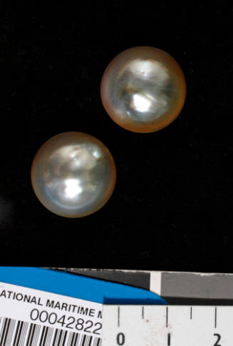 Two cultured half pearls (or mabe pearls), with shell bases
