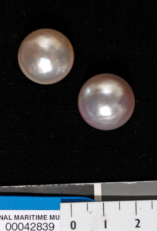 Two cultured half pearls (or mabe pearls) with shell bases