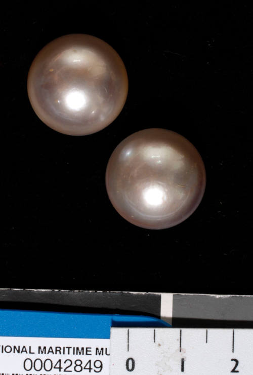 Two cultured half pearls (or mabe pearls) with shell bases