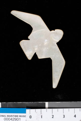 Pearl shell, cut to the shape of a bird