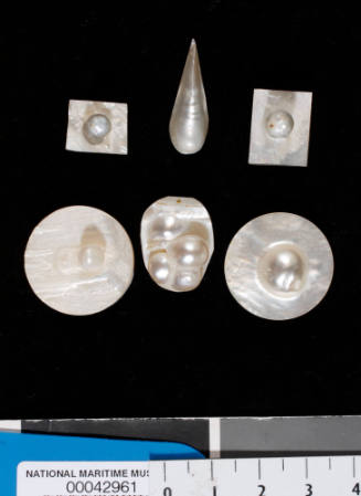 Six small pieces of shell, each with a cultured blister pearl