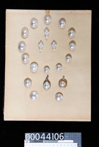 An album page with twenty half pearls (mabe pearls), pearl blisters and pearl pendant, attached with double-sided tape