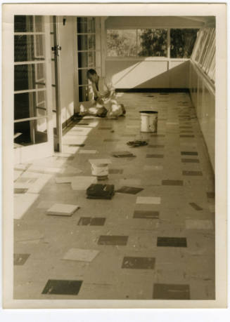 Photograph of a man tiling the floor at Sydney Rowing Club