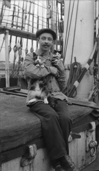 Seaman with a cat and kitten