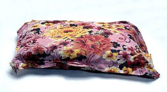 Adult's pillow in floral pillow case, similar to those used on TU DO