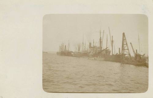 Ships and a submarine at a wharf