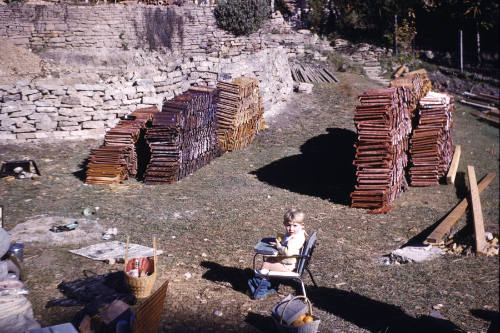 Small child seated in a chair on a building construction site slide