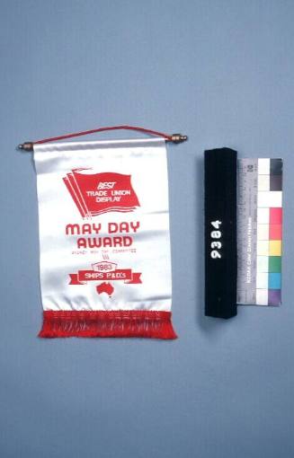 May Day Award in the shape of a miniature banner from the May Day Committee 1983