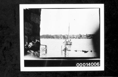 Bow view of yacht being rowed towards a mooring post