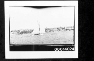 Starboard view of white hulled cutter under sail, Sydney Harbour