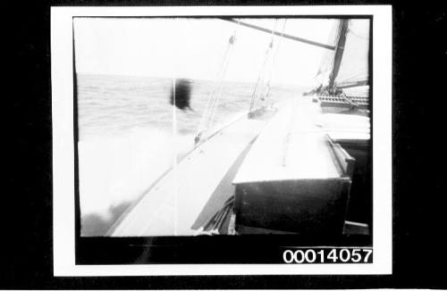 Port side deck of yacht under sail at sea