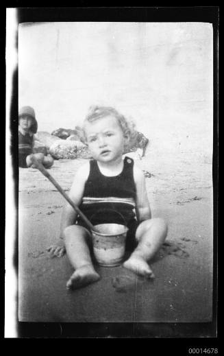 Gloria Smythe on Bondi beach with bucket and spade