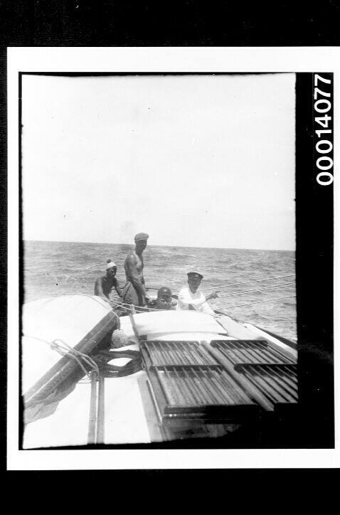 Crew at the stern of yacht UTIEKAH II at sea