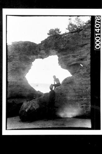 Large hole in a rocky wall at a beach, NSW coast