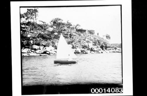 Dinghy under sail in harbour