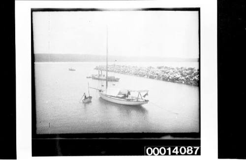 Yacht and motor launch moored in small harbour