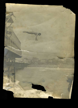 Black and white photograph of Beatrice Kerr diving from a pier