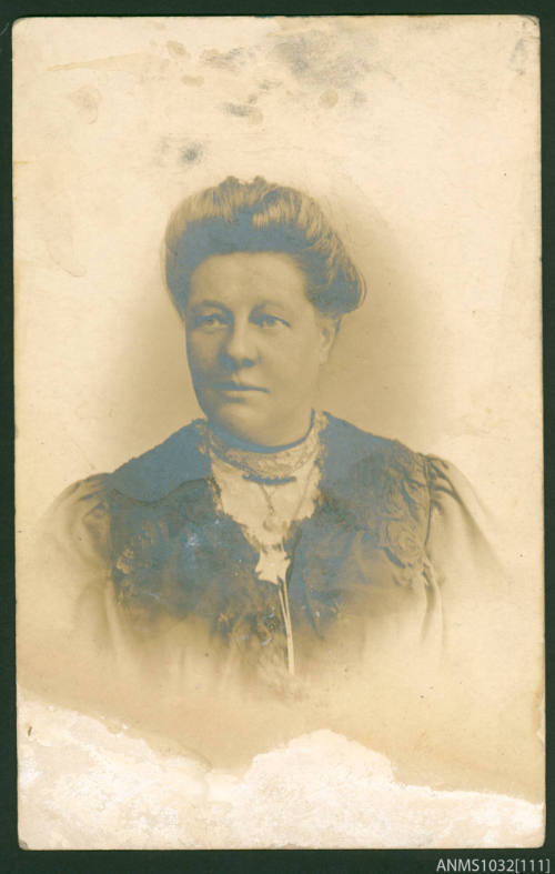 Postcard featuring a black and white portrait photograph of a woman