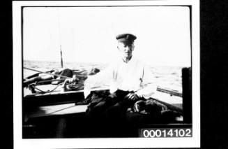 Harold Nossiter Snr holding the tiller of UTIEKAH II at sea