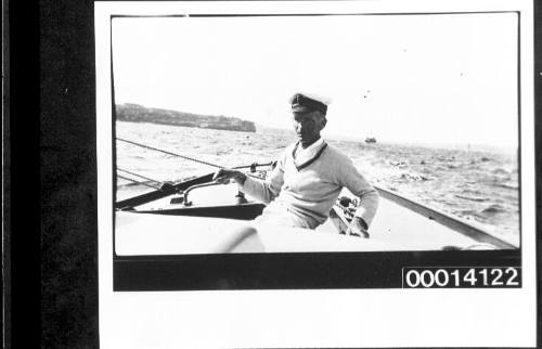 Harold Nossiter Snr in the cockpit of yacht UTIEKAH II under sail