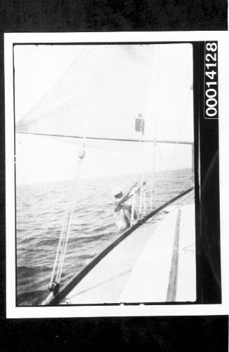 Hanging off the rigging of yacht UTIEKAH II under sail