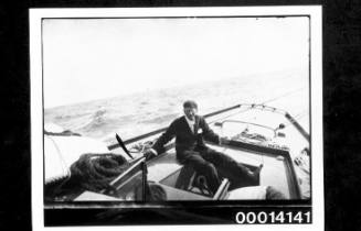 Harold Nossiter Snr in the cockpit of yacht UTIEKAH II