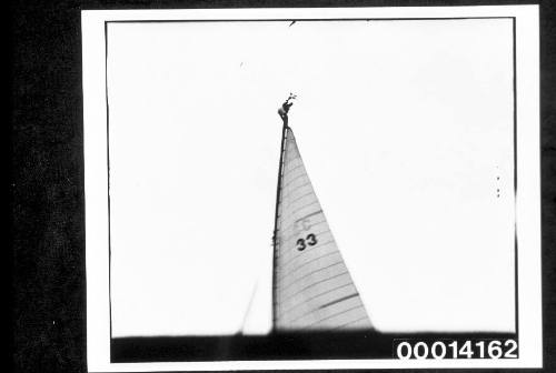 Person with a club burgee at the top of a mast