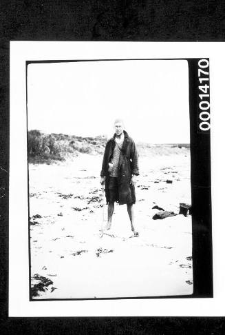 Man standing on a sandy shore