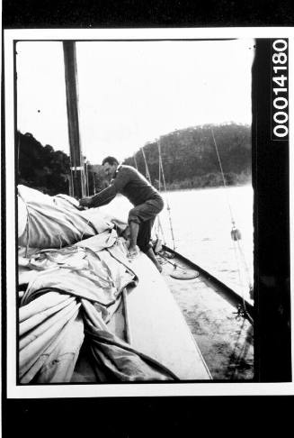 Man working on the sails of yacht UTIEKAH II