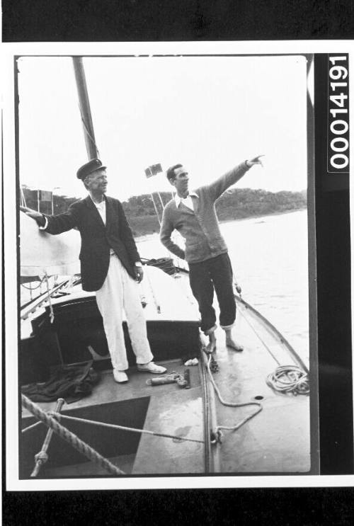 Men standing on the deck of yacht UTIEKAH II