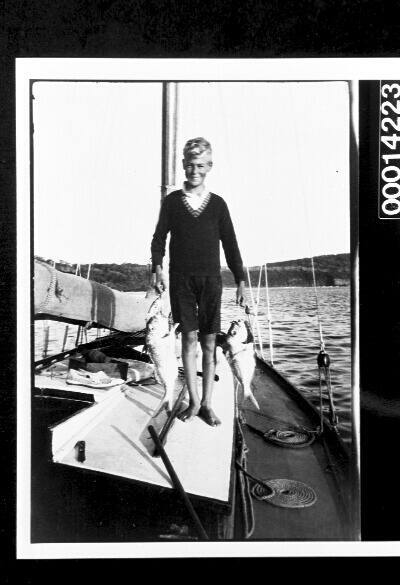 Boy holding two snapper on the deck of UTIEKAH II - cruise to Sugar Loaf Bay