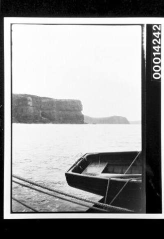 View of rocky headlands from the deck of a yacht