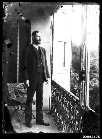 Portrait of a man standing on a verandah