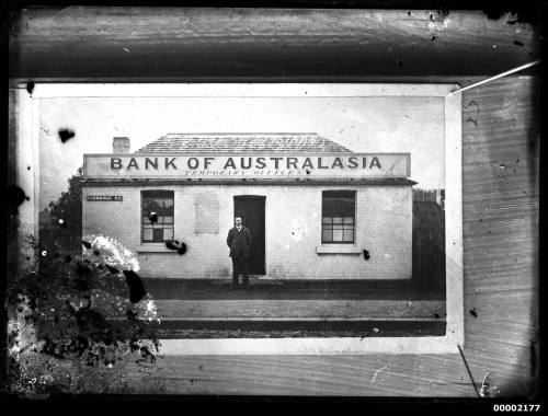 Man standing outside the Bank of Australasia (temporary office), Stanmore Road, Sydney