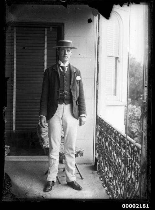 Portrait of a man standing on a verandah