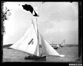 22-footer sailing off Garden Island, Sydney Harbour, displaying the number '3' and a dark stripe on the mainsail and a small maltese cross at the peak of the mast