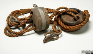 Joined pair of wooden pulley blocks for running rigging on a sailing ship.