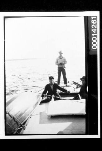 Men at the stern of yacht UTIEKAH II at sea