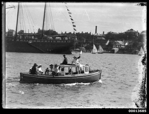 Motor launch carrying a group of spectators on Sydney Harbour