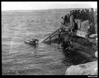 Capsized skiff dragged to shore at Clark Island, Sydney