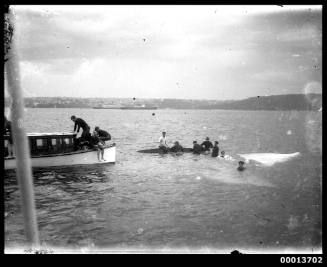 Crew of a swamped skiff being picked up by a motor launch, Sydney